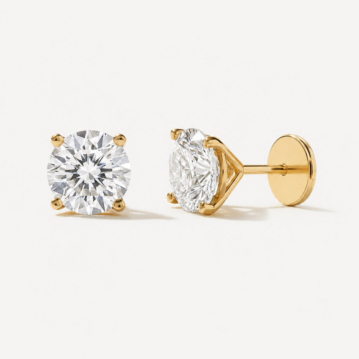 Round-Cut Diamond Stud Earrings: round diamond stud earrings showing yellow gold posts and backs.