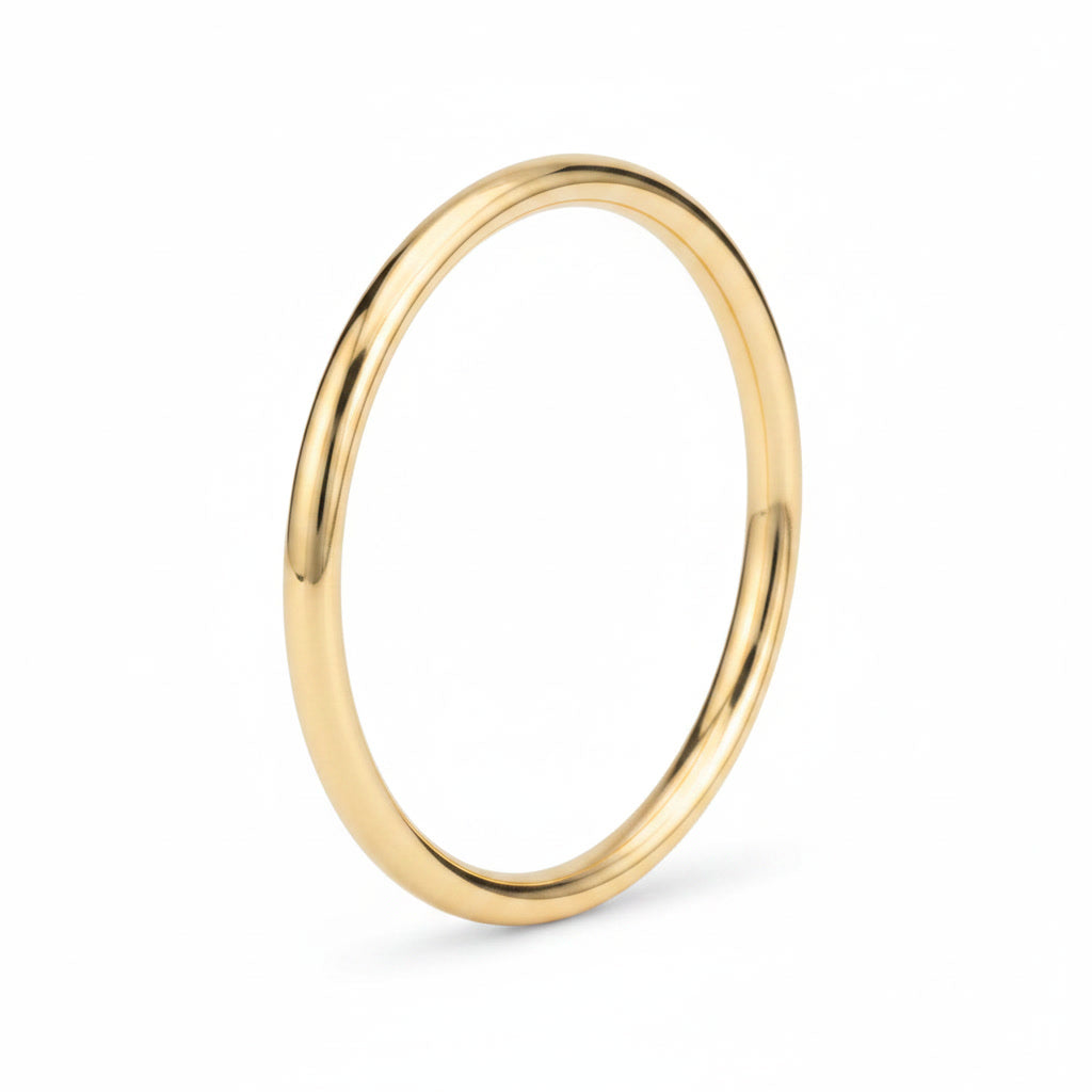 Classic Gold Bangle Bracelet: classic polished yellow gold bangle, angled view.
