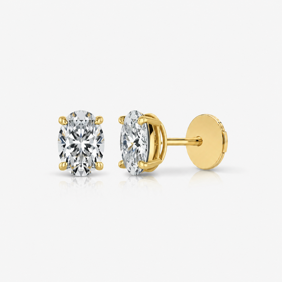 Oval-cut diamond stud earrings showing gold posts and backs.