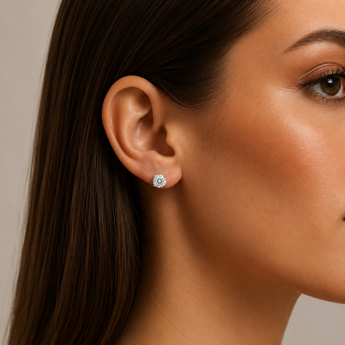 Round Brilliant Diamond Stud Earrings: model wearing a round brilliant diamond stud earring.