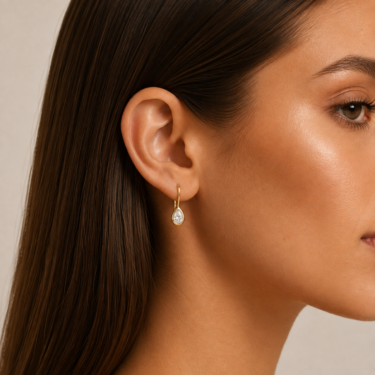 Pear-Cut Diamond Drop Earrings: model wearing a pear-shaped diamond drop earring.