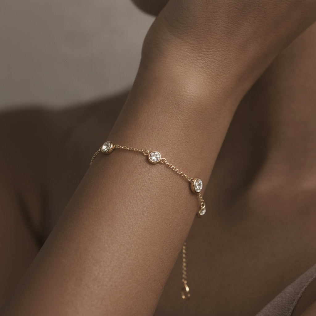 Diamond station chain bracelet worn on a wrist.