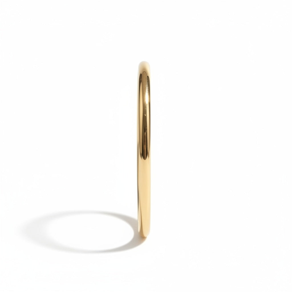 Classic Gold Bangle Bracelet: side view of a slim polished gold bangle.